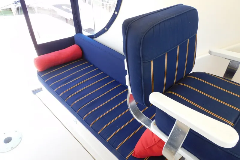 Slide: The Image of Blue and striped seating on 2004 Mainship Pilot 30 Rum Runner boat. - 24