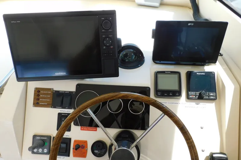 Slide: The Image of 2004 Mainship Pilot 30 Rum Runner helm with Garmin and Raymarine navigation displays. - 15