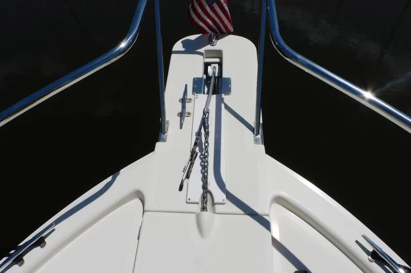 Slide: The Image of Bow of 2004 Mainship Pilot 30 Rum Runner with anchor chain and American flag. - 9