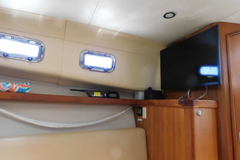 Slide: The Image of Interior of 2004 Mainship Pilot 30 Rum Runner with TV and portholes. - 29