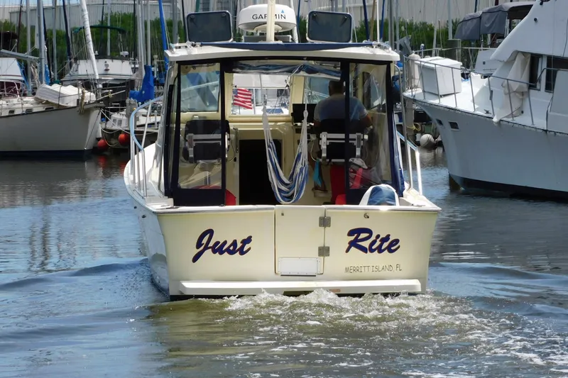 Slide: The Image of 2004 Mainship Pilot 30 Rum Runner boat named "Just Rite" in a marina setting. - 6