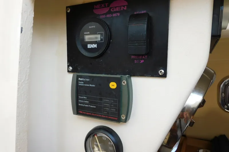 Slide: The Image of Control panel of a 2004 Mainship Pilot 30 Rum Runner boat, featuring gauges and switches. - 34