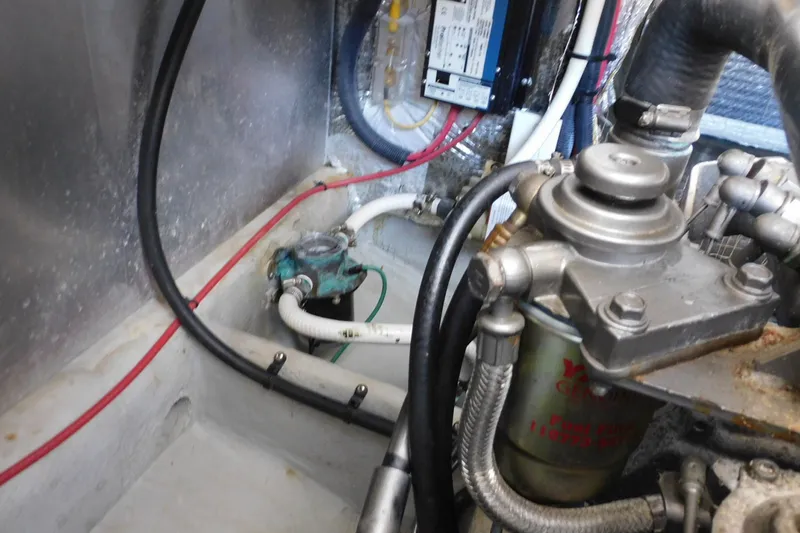 Slide: The Image of Engine compartment of a 2004 Mainship Pilot 30 Rum Runner with visible wiring and components. - 39