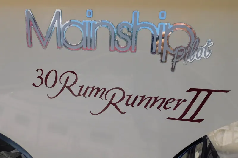 Slide: The Image of 2004 Mainship Pilot 30 Rum Runner II boat nameplate with stylish lettering. - 11