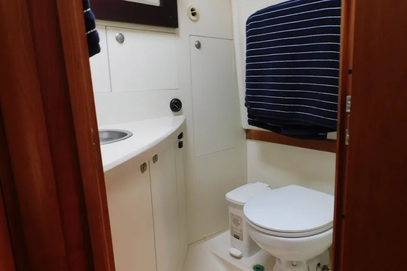 Slide: The Image of Bathroom interior of 2004 Mainship Pilot 30 Rum Runner with sink and toilet. - 31