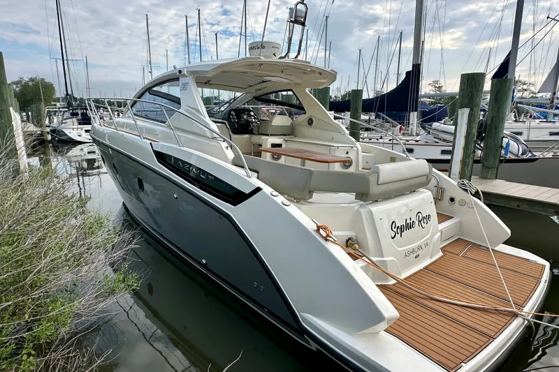 Slide: The Image of 2015 Azimut Atlantis 38 yacht docked at marina with clear sky background. - 1