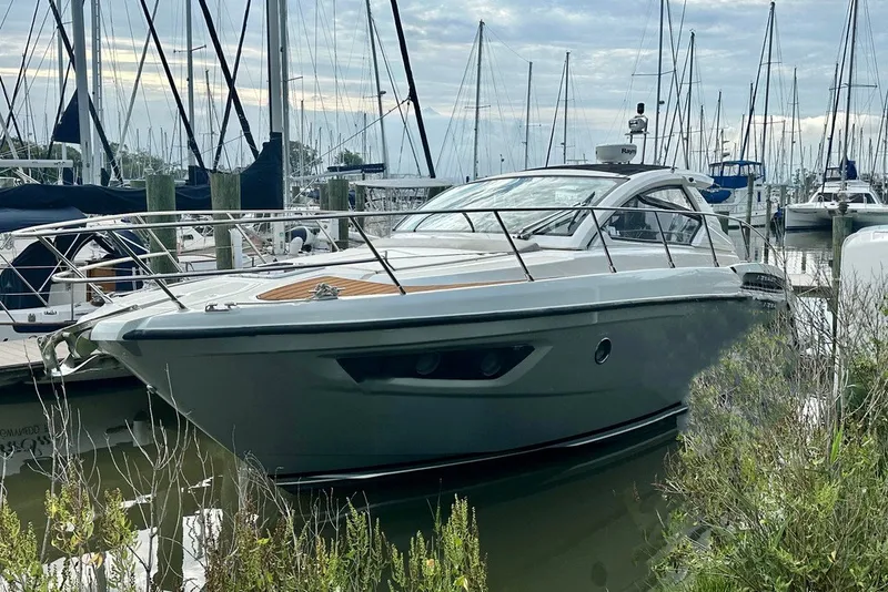 The Image of 2015 Azimut Atlantis 38 yacht docked in a marina, surrounded by sailboats. - 0