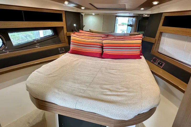 Slide: The Image of Luxurious cabin interior of 2015 Azimut Atlantis 38 yacht with cozy bed and striped pillows. - 17