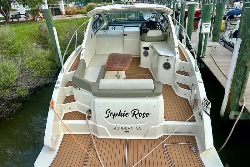 Slide: The Image of 2015 Azimut Atlantis 38 yacht docked, featuring teak deck and seating area. - 2