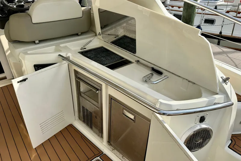 Slide: The Image of Azimut Atlantis 38 yacht interior, featuring a kitchenette with grill and sink, 2015 model. - 9