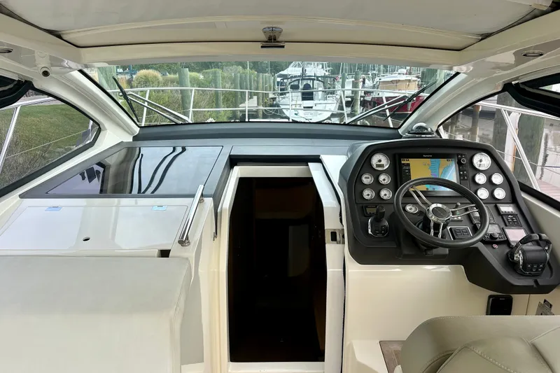 Slide: The Image of Helm of 2015 Azimut Atlantis 38 yacht with modern navigation controls and steering wheel. - 10