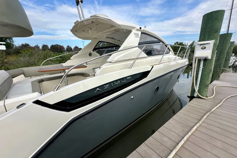 Slide: The Image of Azimut Atlantis 38 yacht docked, showcasing sleek design and modern features, 2015 model. - 4