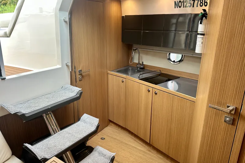 Slide: The Image of Interior of 2015 Azimut Atlantis 38 yacht featuring a compact kitchen area. - 16