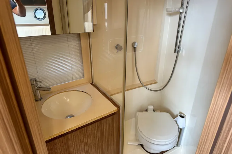 Slide: The Image of Bathroom interior of 2015 Azimut Atlantis 38 yacht, featuring sink, toilet, and shower. - 19