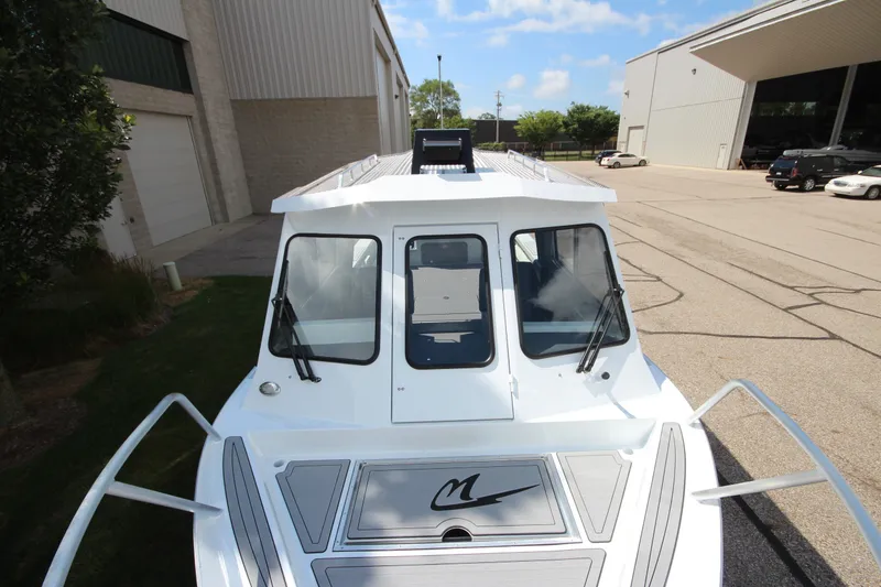 Slide: The Image of 2027 Weldcraft 240 Ocean King boat at a marina, showcasing sleek design and modern features. - 36