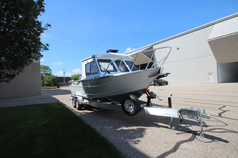 Slide: The Image of 2027 Weldcraft 240 Ocean King boat on trailer, parked outside industrial building. - 5