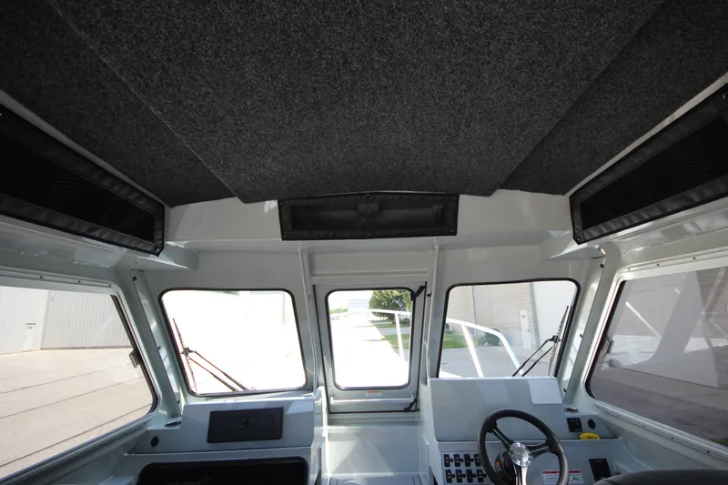 Slide: The Image of Interior view of 2027 Weldcraft 240 Ocean King boat cockpit with steering wheel and controls. - 32