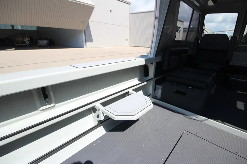 Slide: The Image of Interior view of 2027 Weldcraft 240 Ocean King boat, featuring seating and storage. - 19