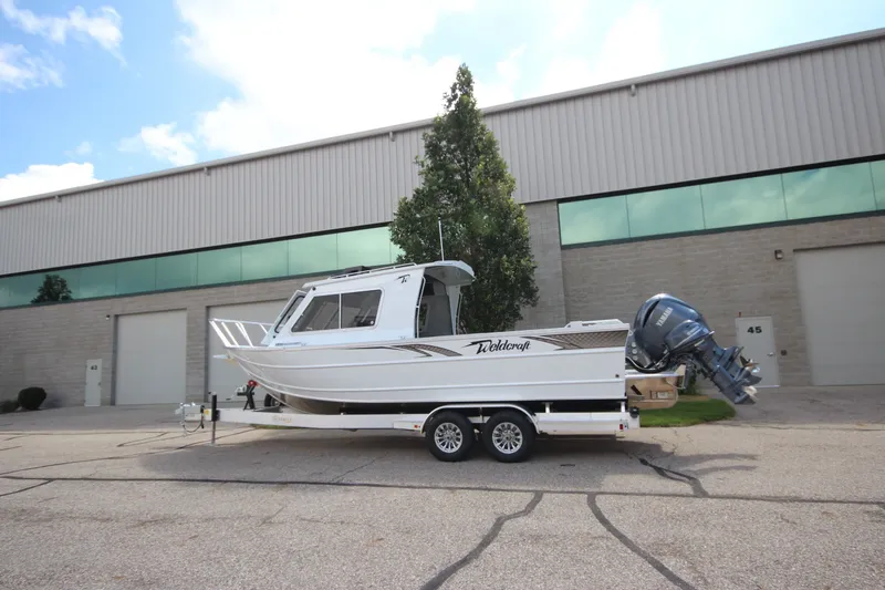 Slide: The Image of 2027 Weldcraft 240 Ocean King boat on trailer outside industrial building. - 39