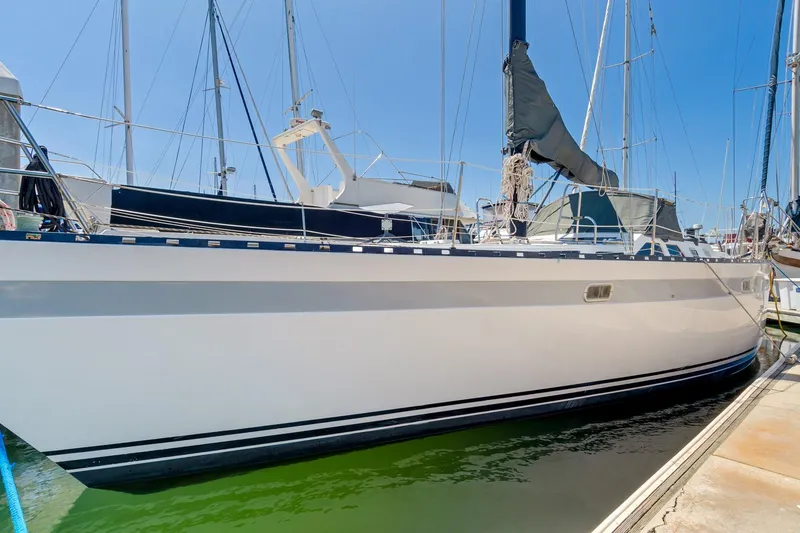 Slide: The Image of 1987 Macintosh Center Cockpit sailboat docked in marina under clear blue sky. - 39