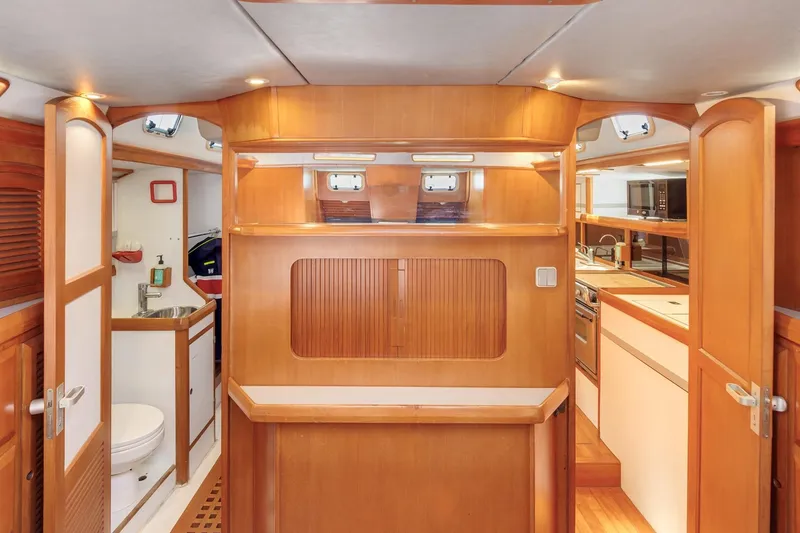Slide: The Image of Interior of 1987 Macintosh Center Cockpit yacht with wood finish and modern amenities. - 17