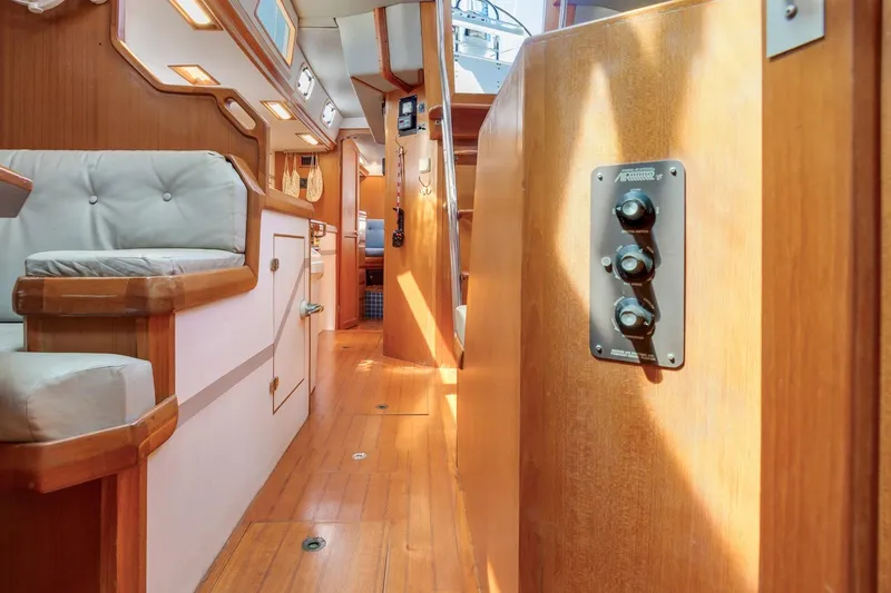 Slide: The Image of Interior of a 1987 Macintosh Center Cockpit yacht with wooden finishes and seating. - 13