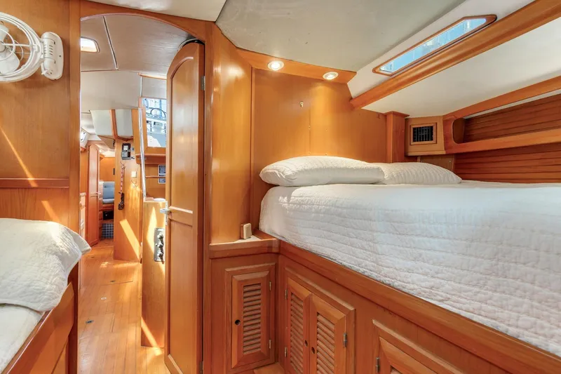 Slide: The Image of Cozy interior of 1987 Macintosh Center Cockpit yacht with wooden furnishings and comfortable bedding. - 21