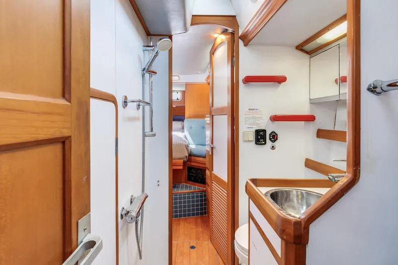 Slide: The Image of 1987 Macintosh Center Cockpit yacht interior with wooden cabinetry and compact bathroom. - 19