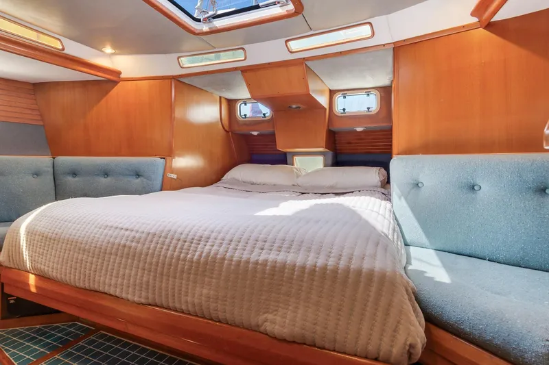 Slide: The Image of Cozy 1987 Macintosh Center Cockpit yacht cabin with wood paneling and comfortable bedding. - 14