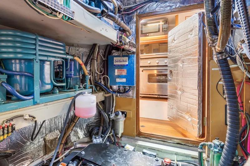 Slide: The Image of Engine room of a 1987 Macintosh Center Cockpit yacht with visible kitchen appliances. - 34