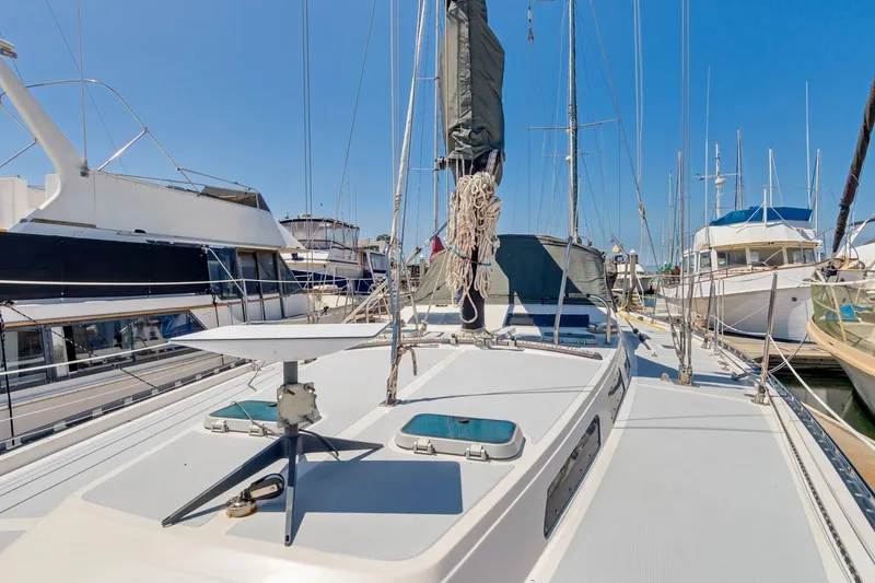 Slide: The Image of 1987 Macintosh Center Cockpit sailboat docked at a marina, surrounded by other boats. - 43