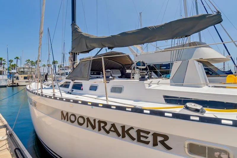 The Image of 1987 Macintosh Center Cockpit sailboat "Moonraker" docked at marina under clear blue sky. - 0