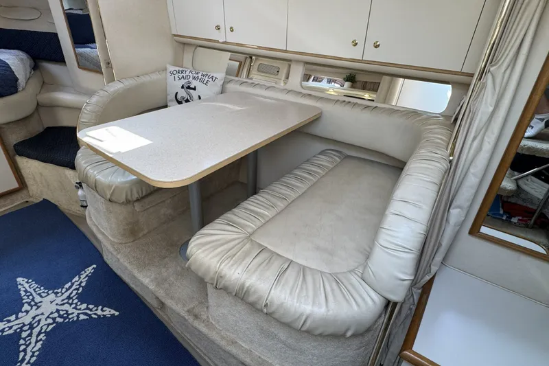 Slide: The Image of Interior of 2000 Sea Ray 340 Sundancer with cushioned seating and dining table. - 20