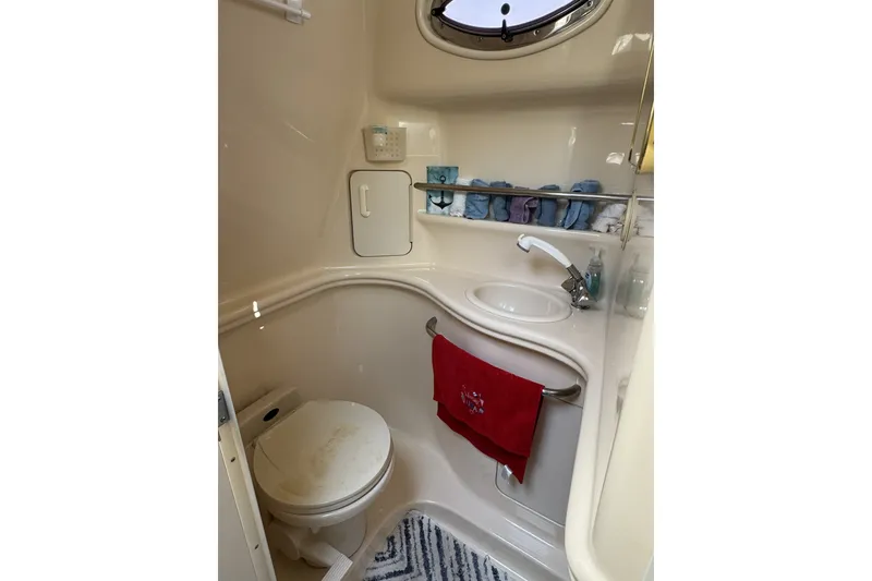 Slide: The Image of Compact bathroom in a 2000 Sea Ray 340 Sundancer yacht, featuring sink and toilet. - 23