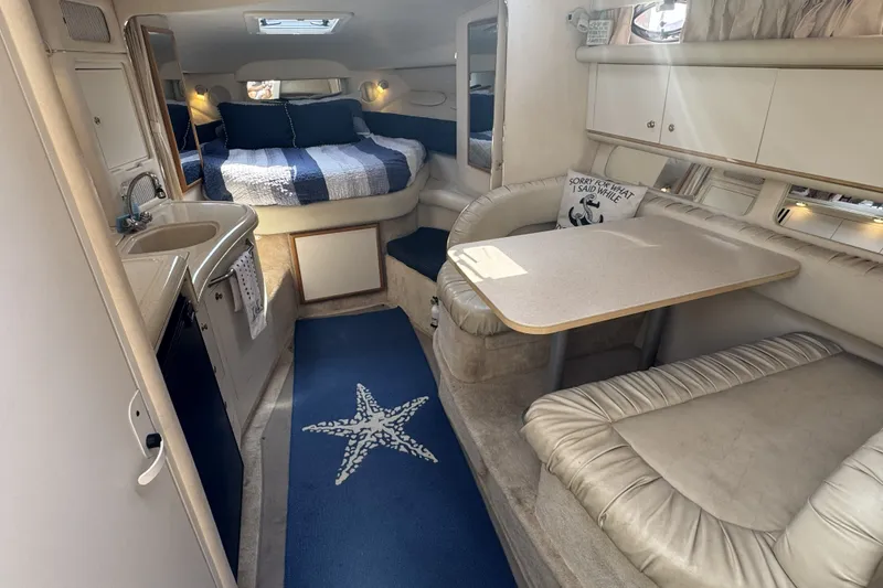 Slide: The Image of Interior of 2000 Sea Ray 340 Sundancer yacht with cozy seating and sleeping area. - 14