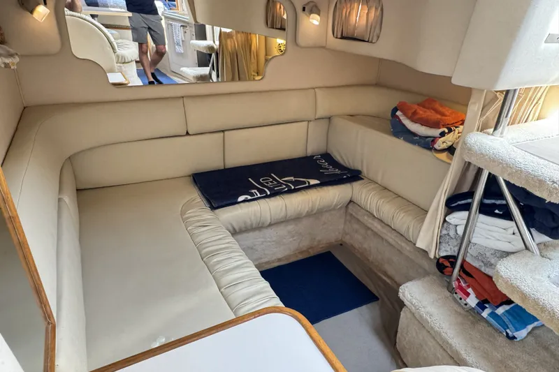 Slide: The Image of Interior of a 2000 Sea Ray 340 Sundancer yacht with beige seating and cozy decor. - 22