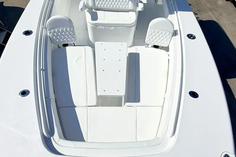 Slide: The Image of 2027 Sea Hunt Ultra 285SL boat interior with white seating and table setup. - 25