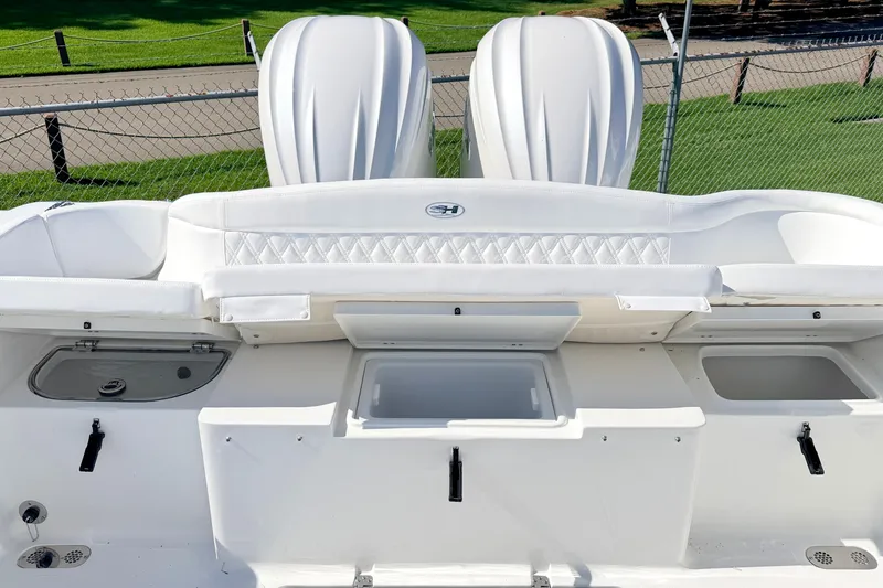 Slide: The Image of 2027 Sea Hunt Ultra 285SL boat interior with white seating and storage compartments. - 12