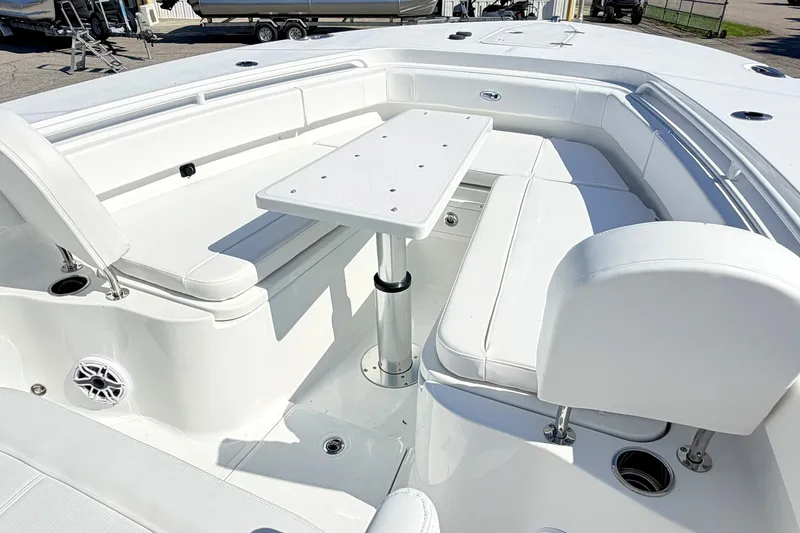 Slide: The Image of Luxurious seating area on 2027 Sea Hunt Ultra 285SL boat with white upholstery and table. - 22