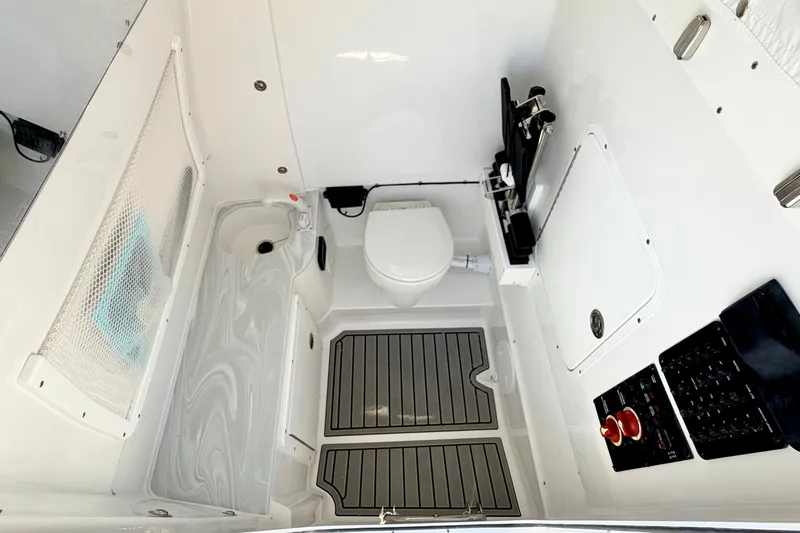 Slide: The Image of Interior of 2027 Sea Hunt Ultra 285SL boat, featuring a compact marine toilet. - 30