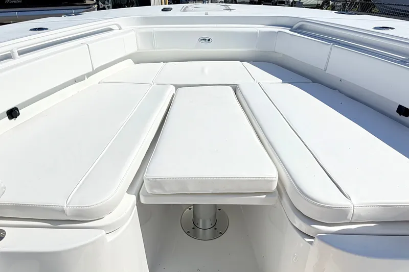Slide: The Image of Spacious seating area on 2027 Sea Hunt Ultra 285SL boat, featuring white cushioned seats. - 28