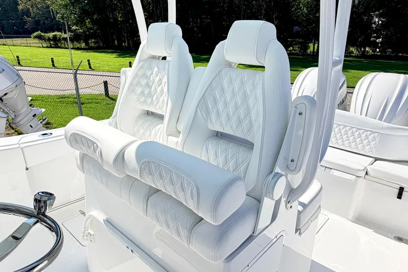 Slide: The Image of Luxurious white seating on 2027 Sea Hunt Ultra 285SL boat, featuring diamond stitching and armrests. - 13