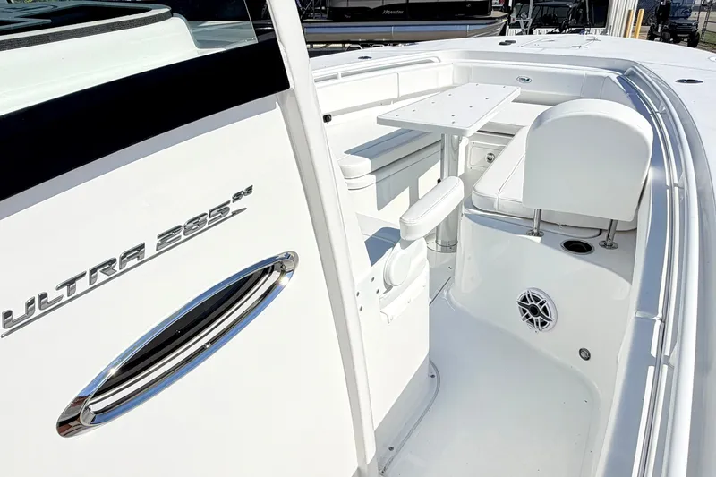 Slide: The Image of 2027 Sea Hunt Ultra 285SL boat interior with seating and table, showcasing modern design. - 21