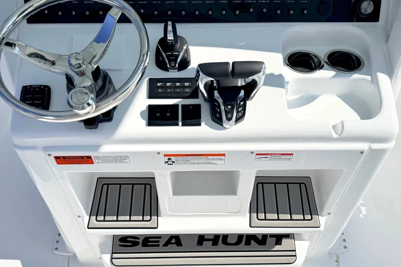 Slide: The Image of 2027 Sea Hunt Ultra 285SL helm with steering wheel and controls. - 20