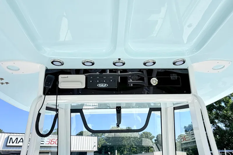 Slide: The Image of 2027 Sea Hunt Ultra 285SL boat console with Garmin electronics and overhead lighting. - 18