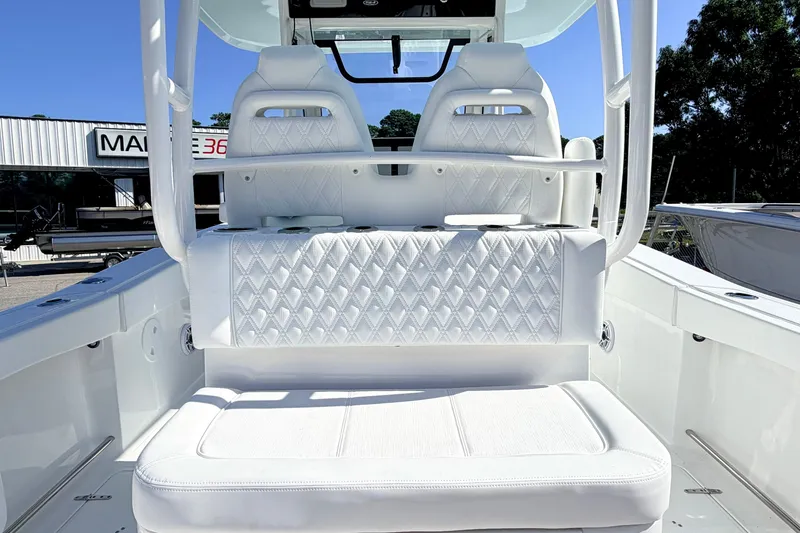 Slide: The Image of 2027 Sea Hunt Ultra 285SL boat interior with white cushioned seating. - 8
