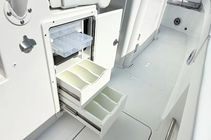 Slide: The Image of Storage compartments on 2027 Sea Hunt Ultra 285SL boat, featuring organized drawers and shelves. - 17