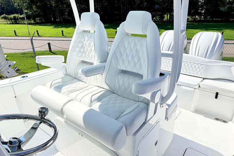 Slide: The Image of Luxurious seating on 2027 Sea Hunt Ultra 285SL boat, featuring white quilted upholstery. - 14