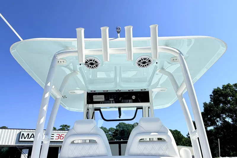 Slide: The Image of 2027 Sea Hunt Ultra 285SL boat with T-top and rod holders under clear blue sky. - 7