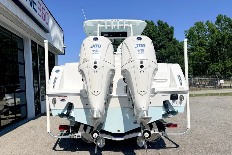 Slide: The Image of 2027 Sea Hunt Ultra 285SL boat with dual 300 V6 engines, parked outdoors. - 3
